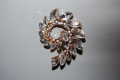 Golden tornado brooch and glitters