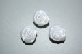 Three white fabric roses