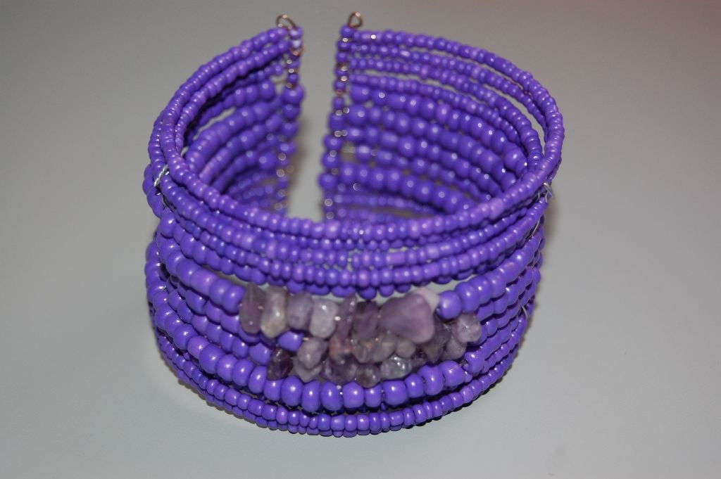 Turns purple bracelet and stones.